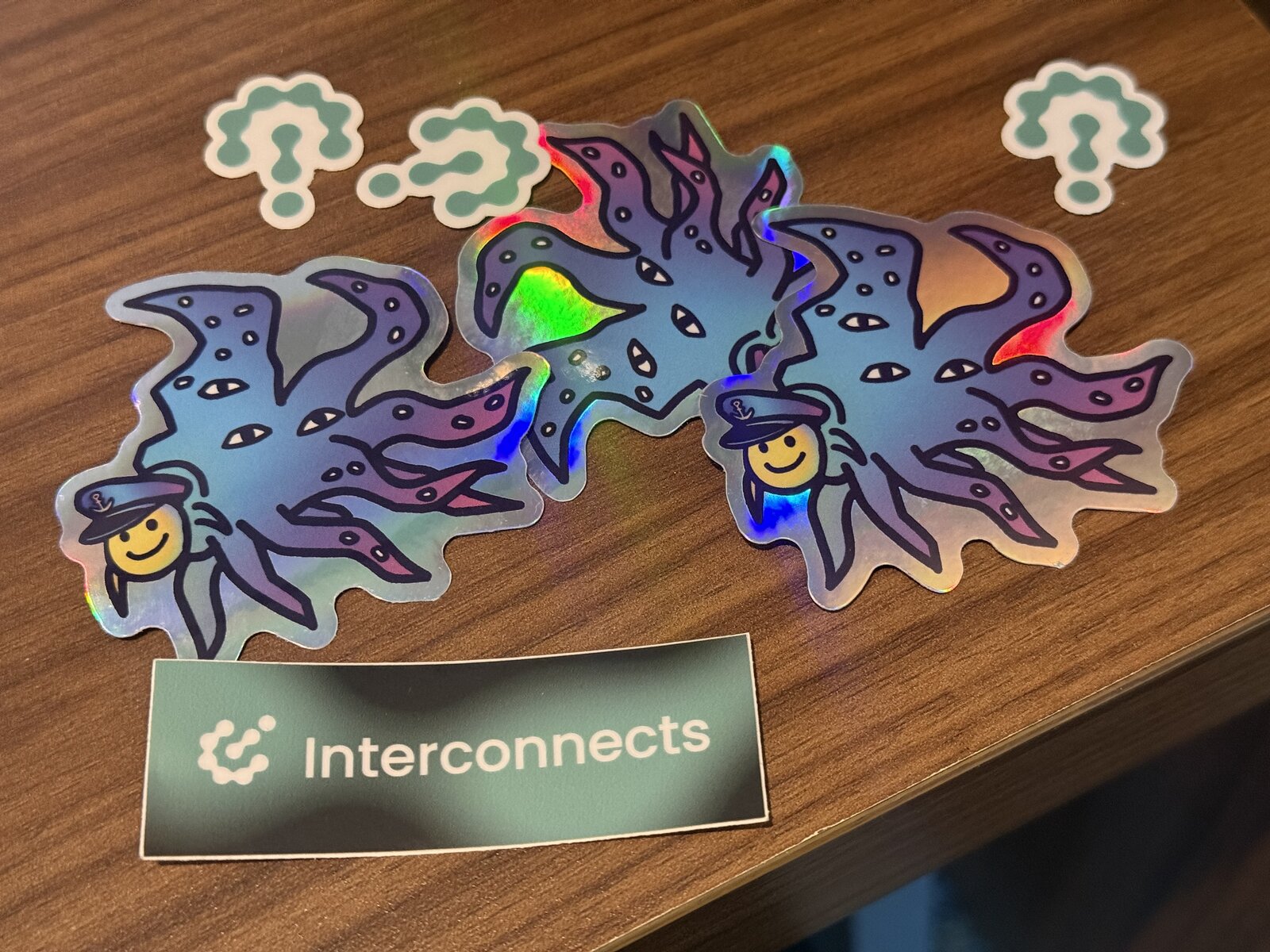 Shoggoth stickers from the Interconnects NeurIPS party, December 2025.